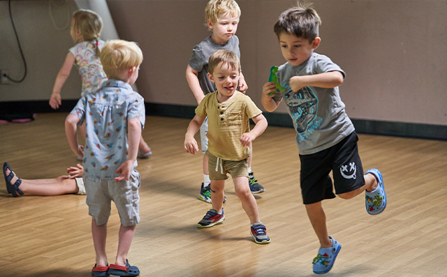 Pre K students in a class jump around together